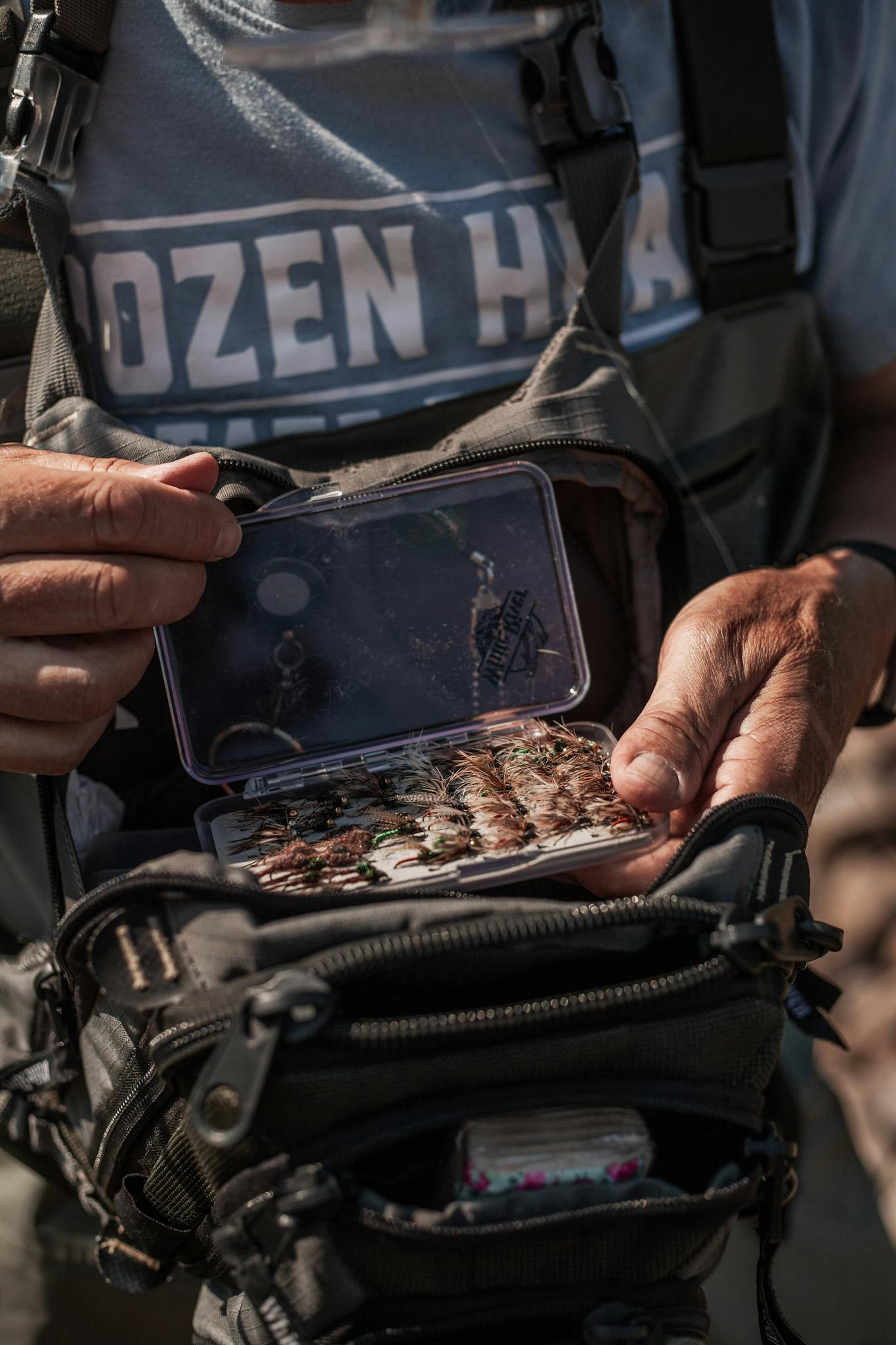 Fisherman Presenting a Box of Various Lures